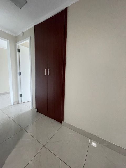 interior space featuring baseboards and light tile patterned flooring