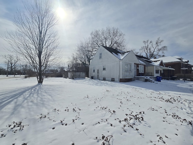 view of snow covered exterior with a garage