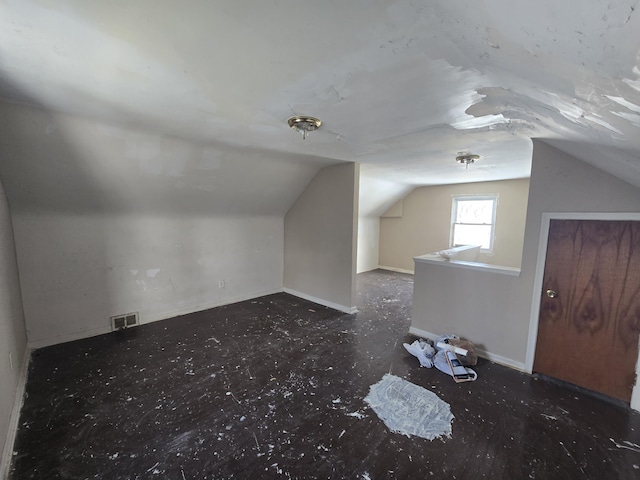 bonus room with visible vents, vaulted ceiling, and baseboards