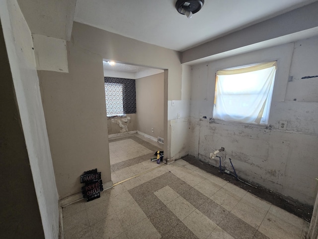 bathroom with a wealth of natural light and tile patterned floors