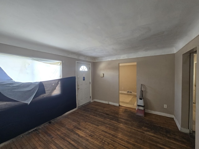 foyer featuring wood-type flooring, visible vents, and baseboards