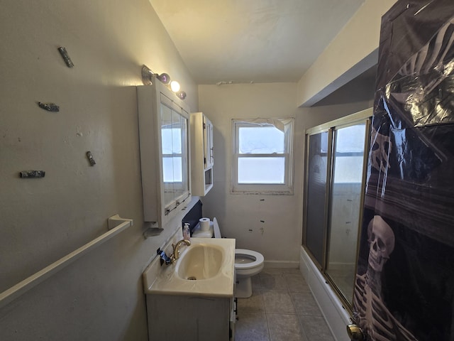 full bathroom featuring tile patterned floors, vanity, toilet, and an enclosed shower