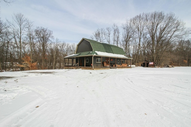 exterior space featuring covered porch and a gambrel roof