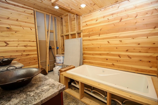 bathroom featuring wooden ceiling, wooden walls, and a bath