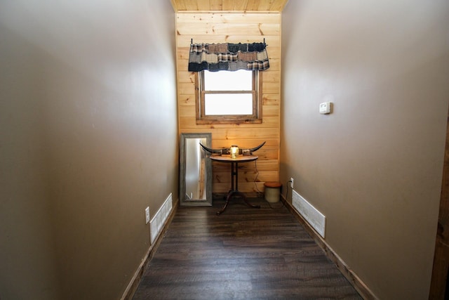 interior space with baseboards, visible vents, and dark wood finished floors