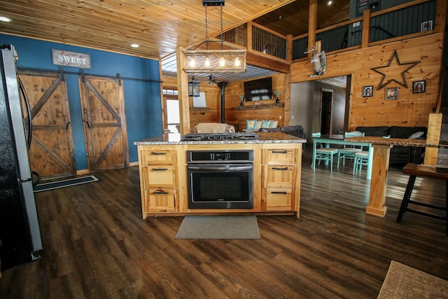 kitchen with wall oven, a barn door, wooden ceiling, dark wood-type flooring, and freestanding refrigerator