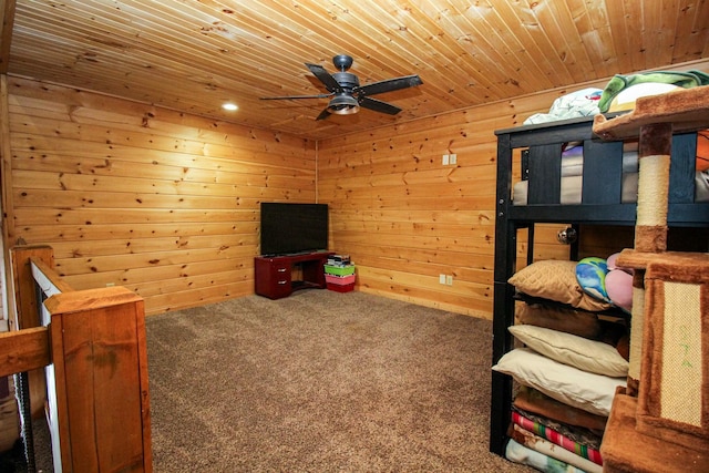 carpeted bedroom featuring wood ceiling and wooden walls