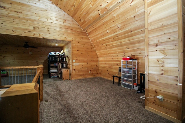 additional living space with wooden ceiling, wooden walls, vaulted ceiling, and carpet flooring