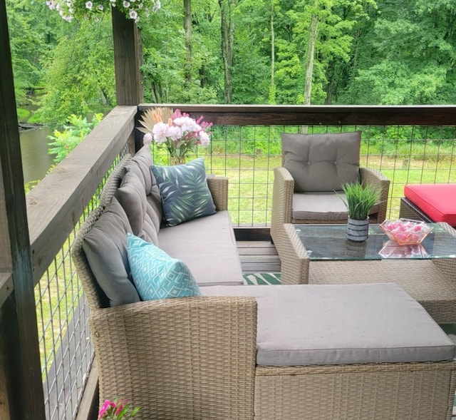 balcony featuring a water view and outdoor lounge area