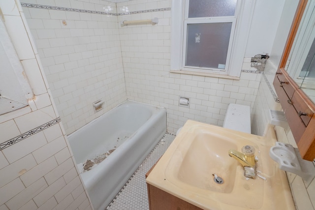 full bath with a sink and tile walls