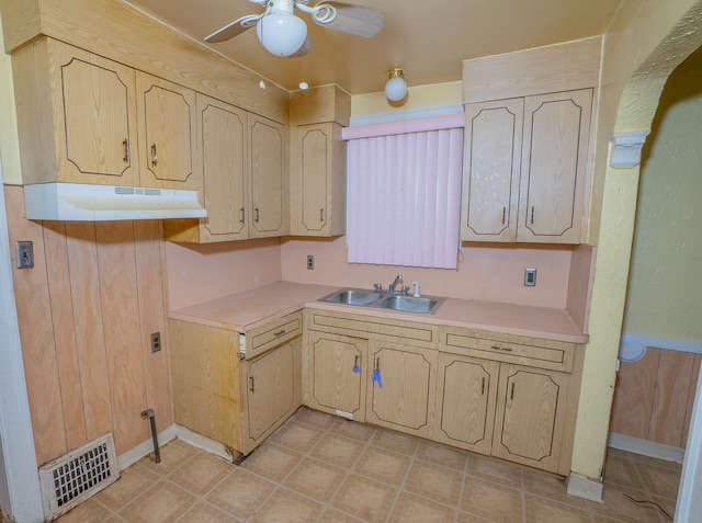 kitchen with under cabinet range hood, visible vents, light countertops, and a sink