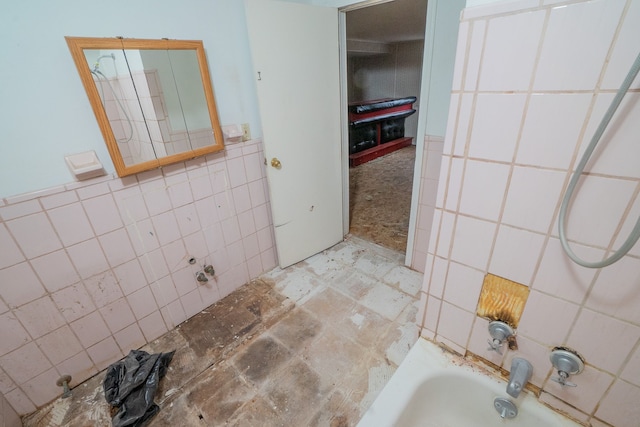 full bathroom featuring  shower combination and tile walls