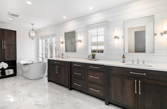 bathroom featuring double vanity, marble finish floor, visible vents, and a sink