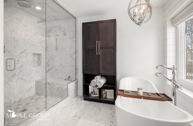 bathroom with a soaking tub, a marble finish shower, marble finish floor, and a notable chandelier