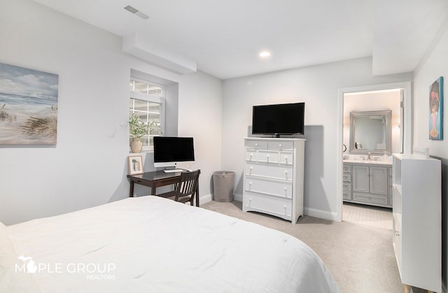 bedroom featuring baseboards, visible vents, a sink, and light colored carpet