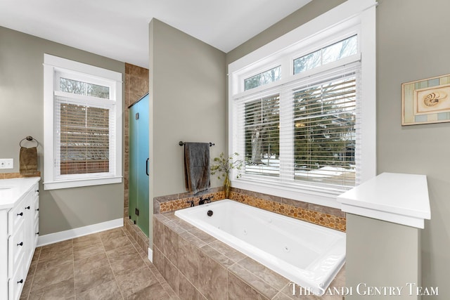 bathroom with baseboards, a tub with jets, tile patterned floors, vanity, and a shower stall