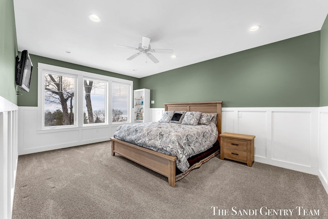 carpeted bedroom with wainscoting, a ceiling fan, and recessed lighting