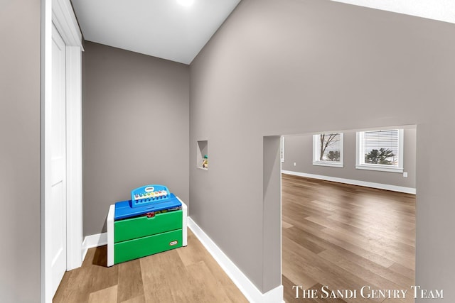 playroom with baseboards and wood finished floors