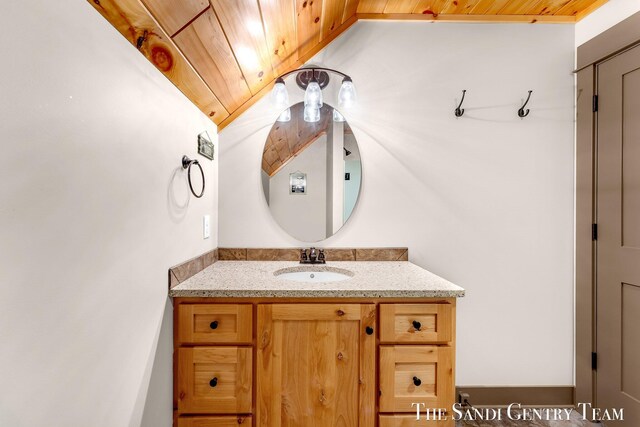 bathroom featuring wood ceiling and vanity