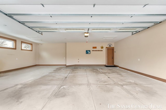 garage with a garage door opener and baseboards