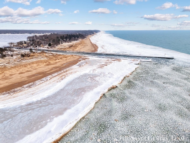 drone / aerial view featuring a water view and a view of the beach