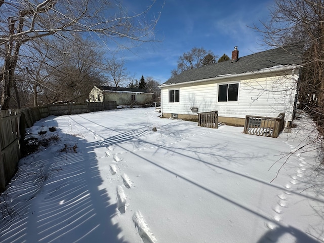 exterior space with a chimney and a fenced backyard