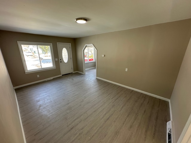 foyer entrance featuring baseboards and wood finished floors