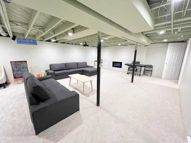 interior space with a glass covered fireplace and carpet flooring