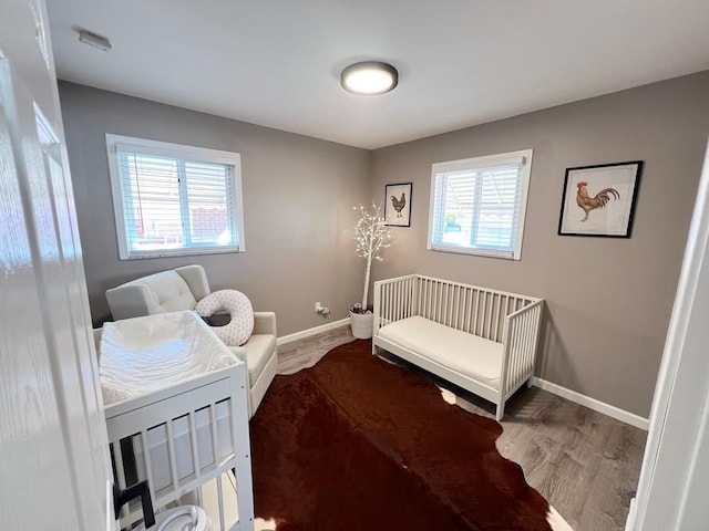 bedroom with baseboards and wood finished floors