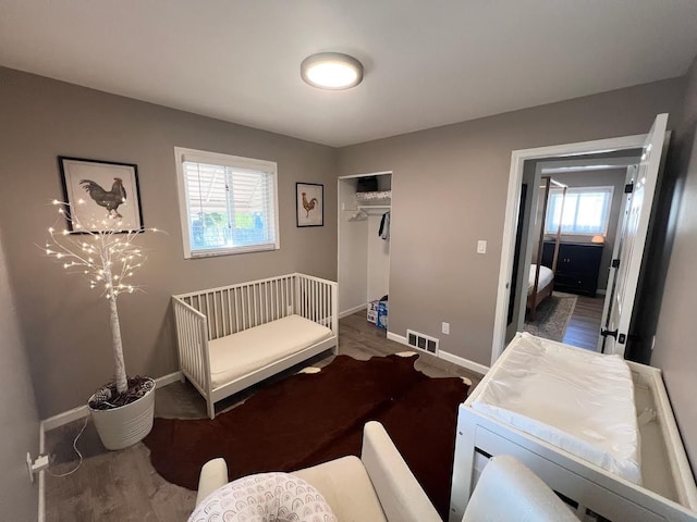 bedroom featuring a closet, visible vents, and baseboards