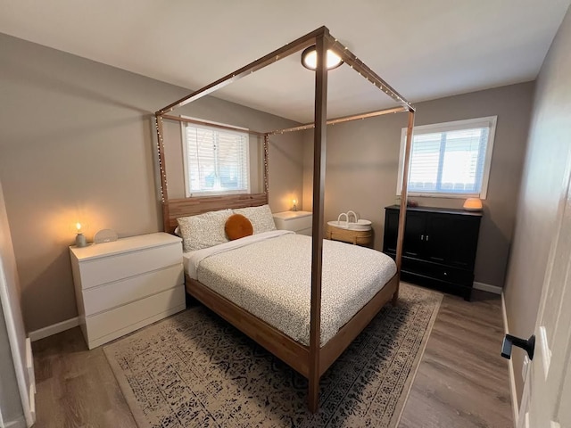 bedroom with light wood-style floors and baseboards