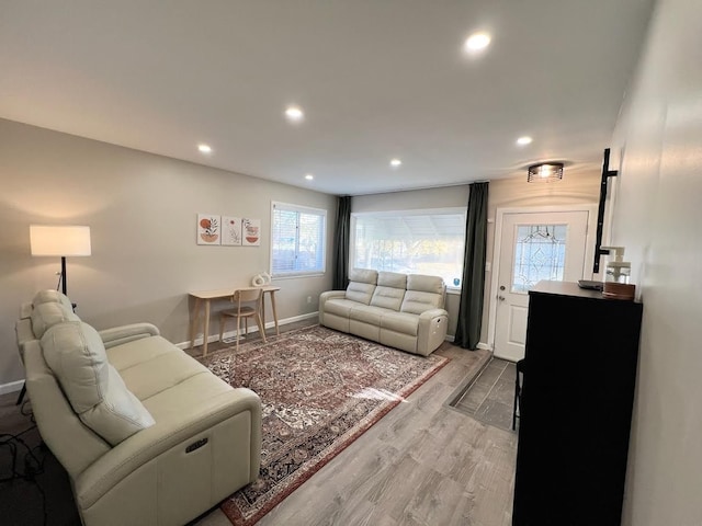 living area featuring recessed lighting, baseboards, and wood finished floors