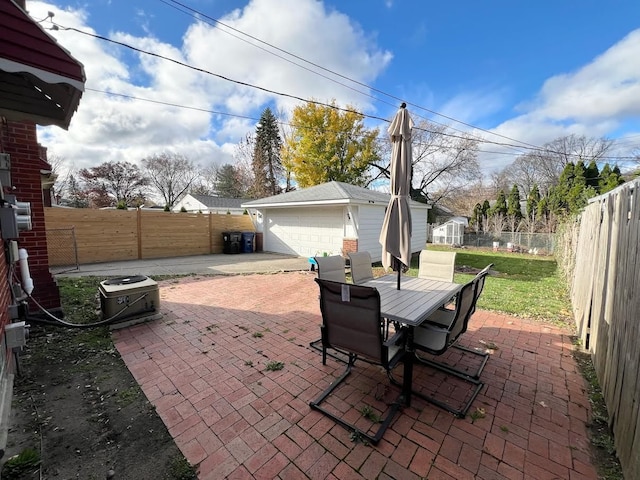 view of patio with a fenced backyard, outdoor dining area, and an outdoor structure