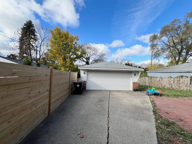 detached garage featuring fence