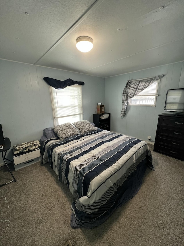 bedroom with a textured ceiling and carpet flooring