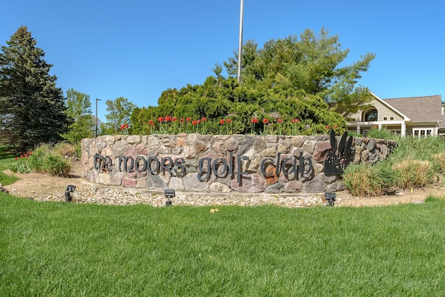 community / neighborhood sign with a lawn