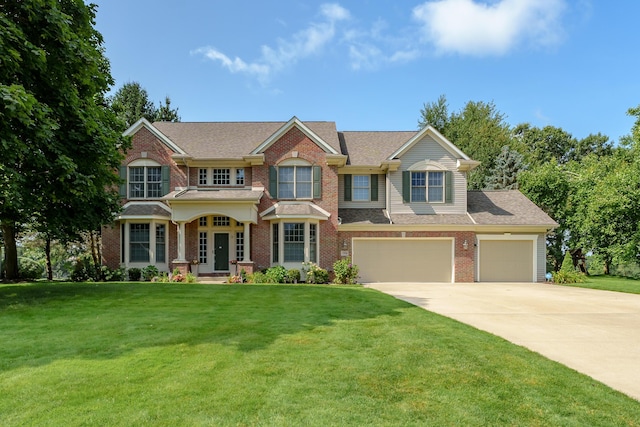 view of front of home with driveway, a front lawn, a shingled roof, and brick siding