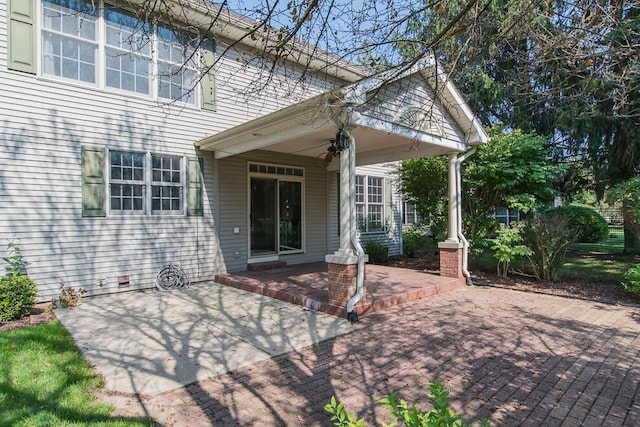 view of exterior entry featuring a patio