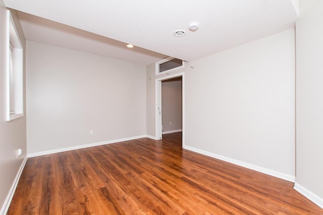 empty room featuring baseboards and wood finished floors