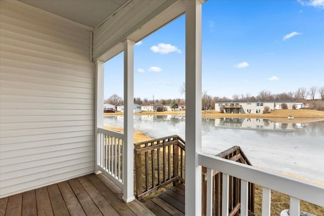 wooden deck featuring a water view