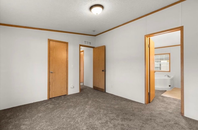 unfurnished bedroom featuring a textured ceiling, visible vents, carpet flooring, and ornamental molding