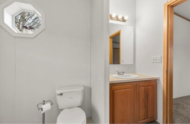 bathroom featuring toilet and vanity