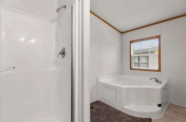 bathroom with a garden tub, crown molding, visible vents, vaulted ceiling, and a shower stall