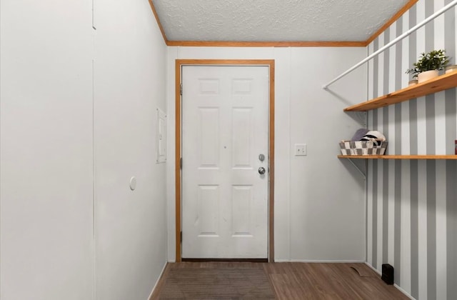 clothes washing area featuring a textured ceiling and wood finished floors