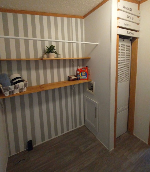 clothes washing area featuring dark wood-style floors, a heating unit, a textured ceiling, laundry area, and wallpapered walls