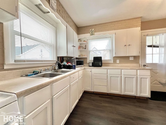 kitchen with open shelves, a healthy amount of sunlight, a sink, and white cabinets