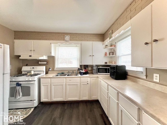 kitchen with open shelves, white cabinets, a sink, white appliances, and under cabinet range hood