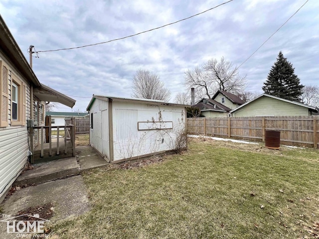 view of yard featuring a fenced backyard and an outdoor structure