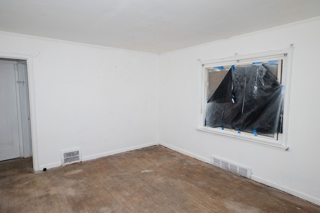 spare room featuring ornamental molding, visible vents, and baseboards