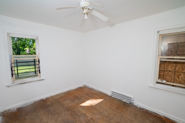 empty room with ceiling fan, visible vents, and baseboards